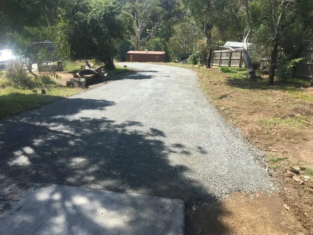 Finished compacted gravel driveway leading through the bush to the property
