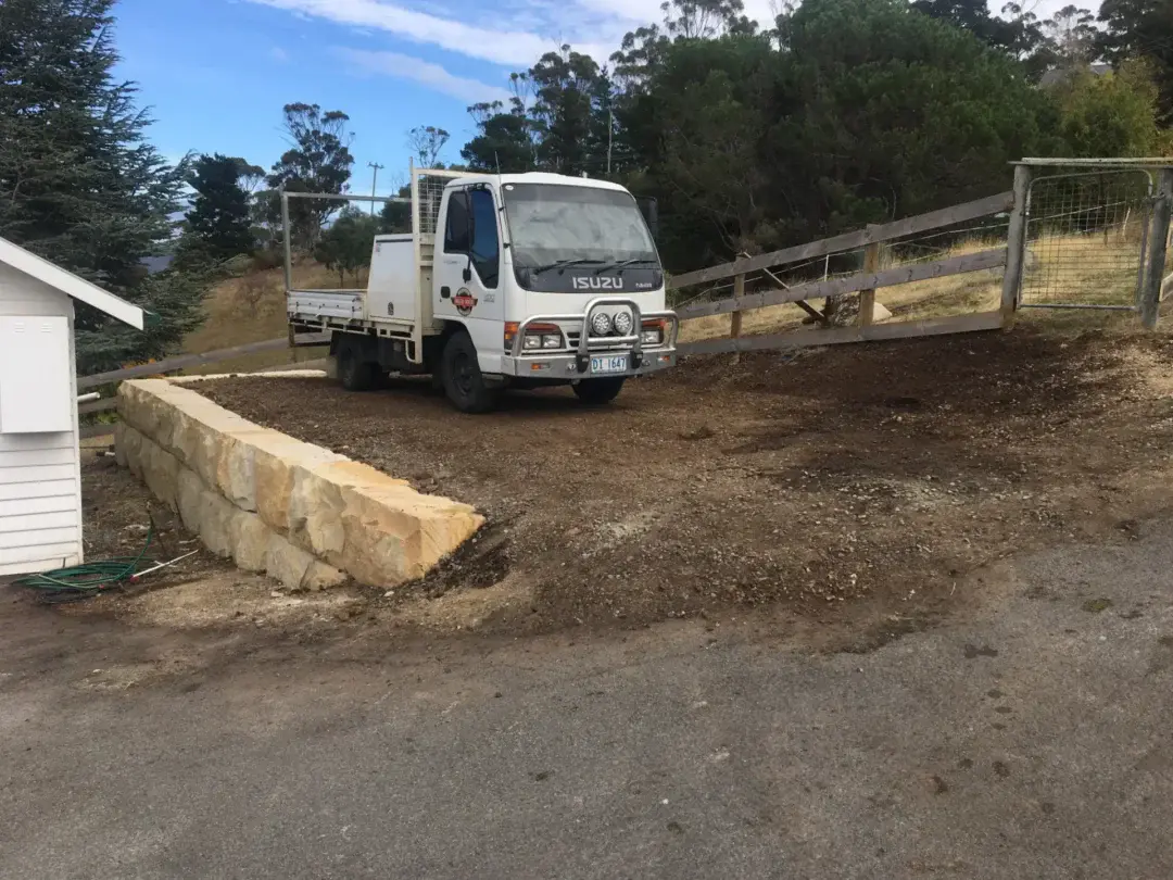 Solid Rock Tasmania truck on site beside a new sandstone block retaining wall